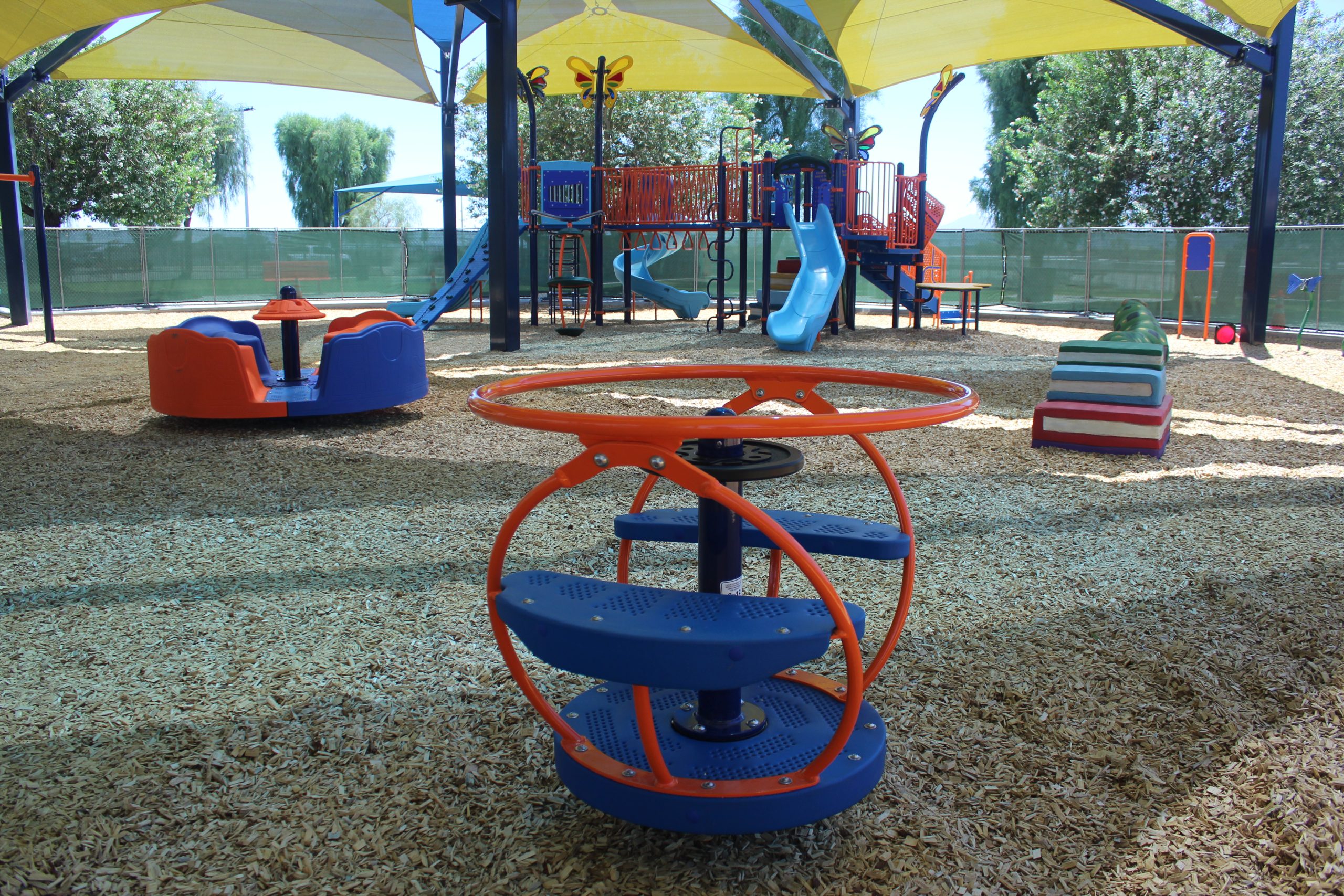 Image showcasing shaded spinners at the City of La Quinta playground, highlighting the combination of active play and sun-safe design in a community space.