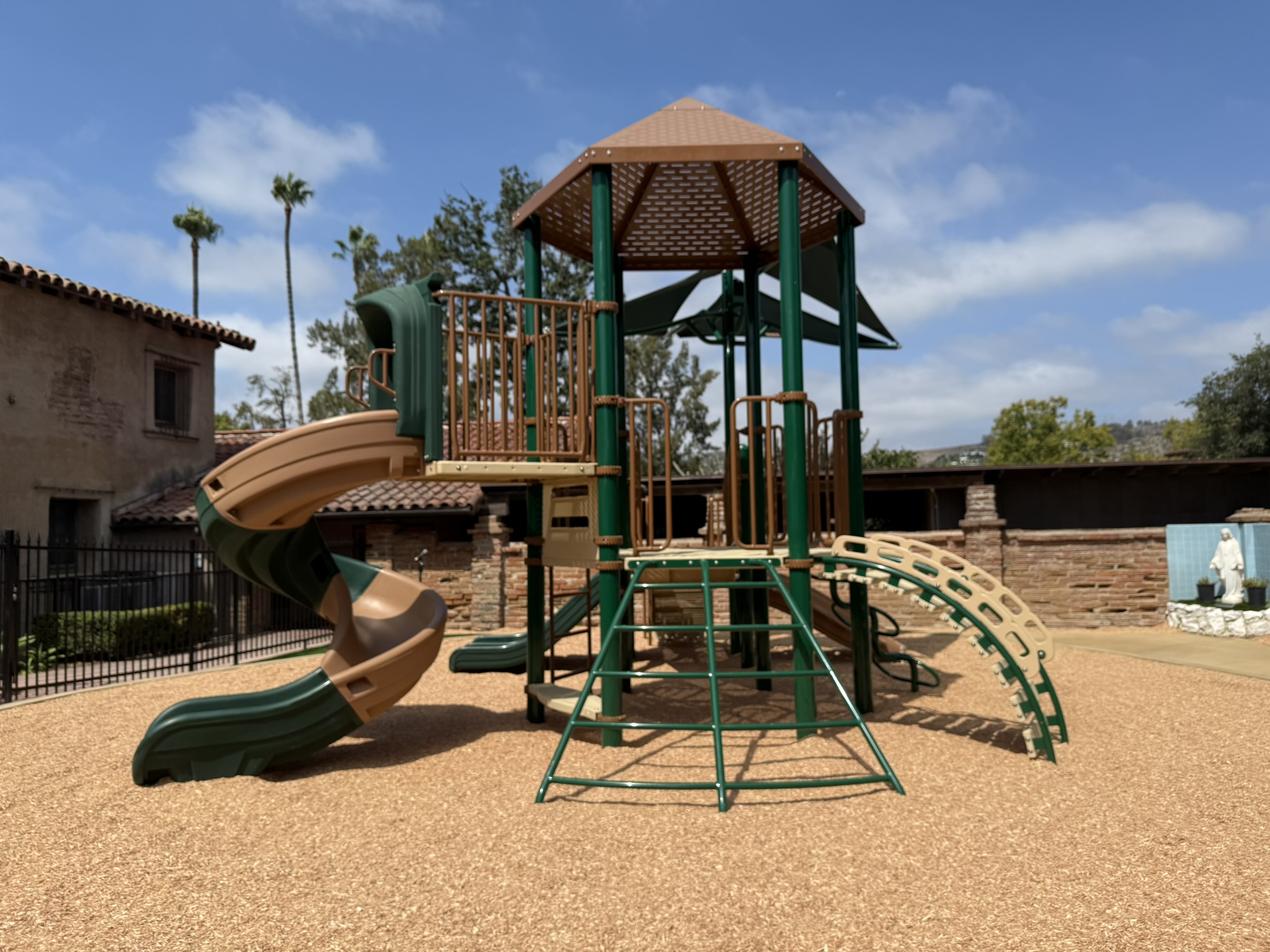 This image illustrates how the playground installation at Mission Basilica was carefully designed to complement and preserve the historic and sacred character of the site, demonstrating a thoughtful approach to integrating modern play spaces within culturally significant environments.