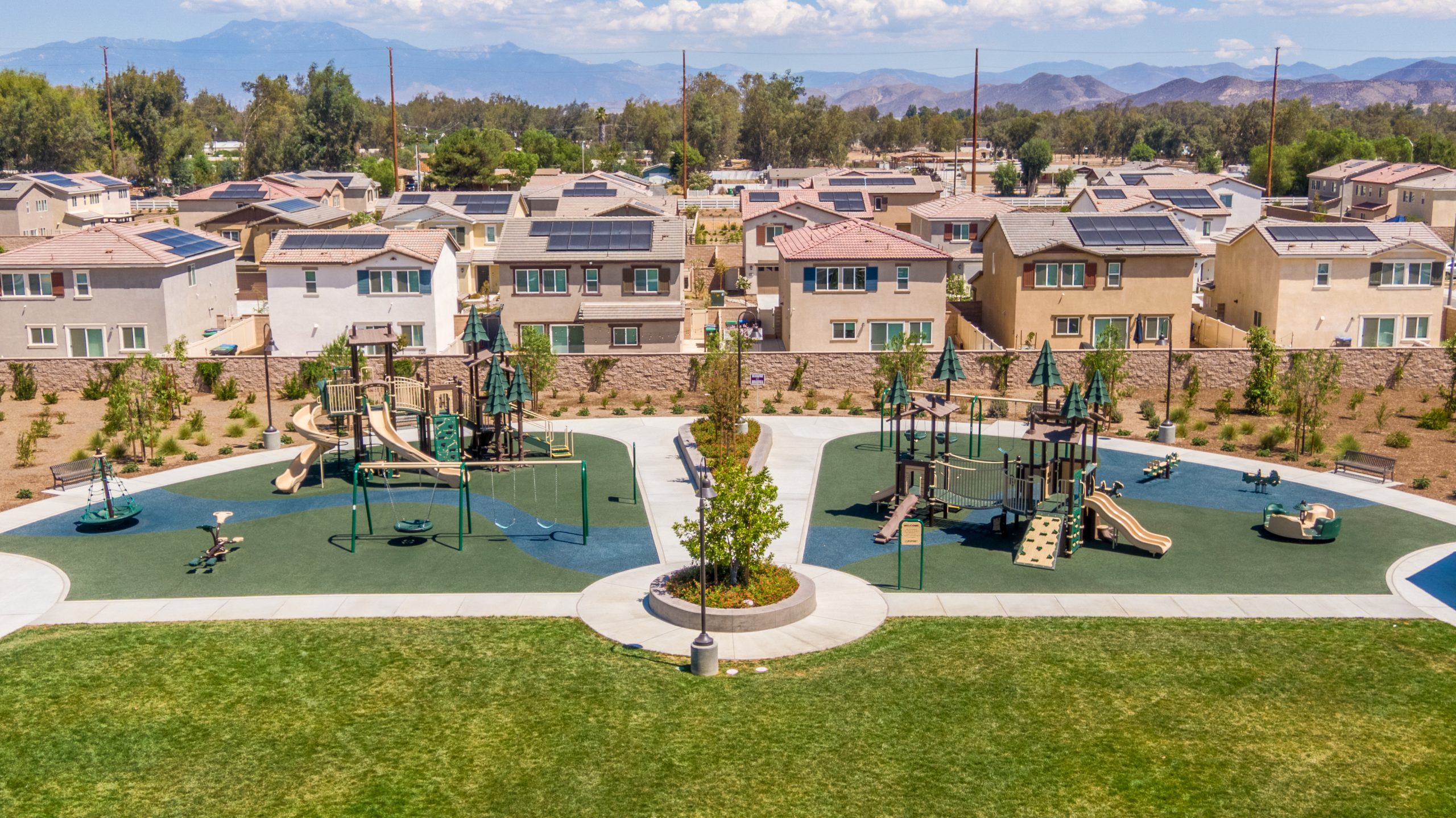 Slides, swings, and forest accents at La Pradera North Park, a Winchester playground project highlighting the playground layout.